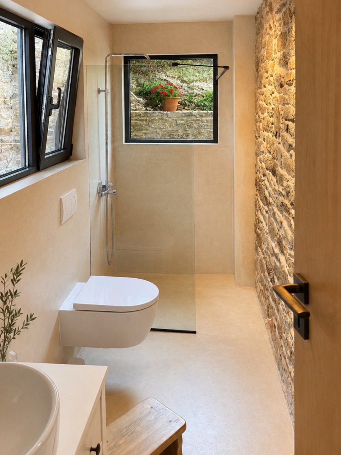 Bathroom with stone wall accent